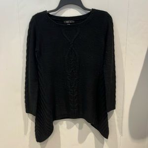 Style & Co. dropped hem sweater with cable front design. Ribbed sides.